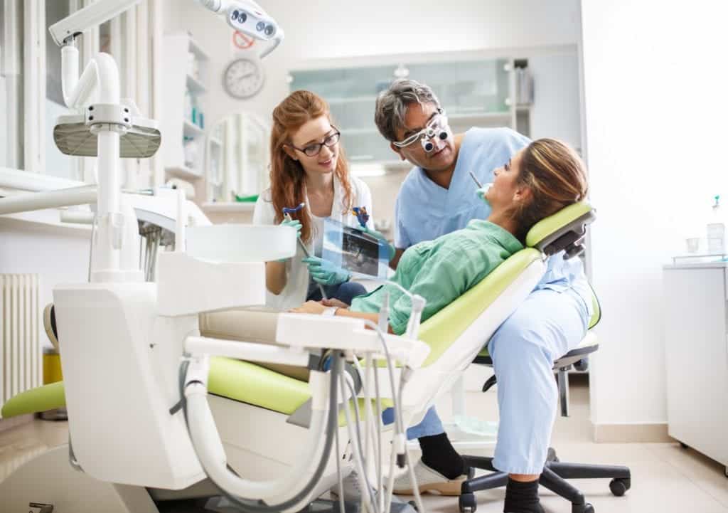 Dentist Hygienist With Patient