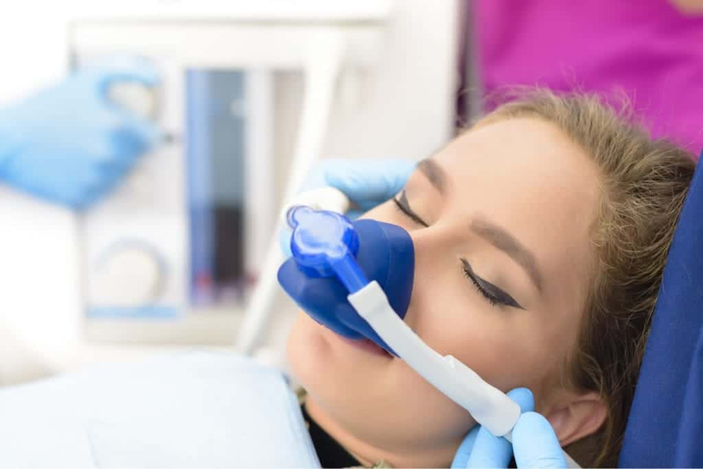 Woman in dental chair with sedation.